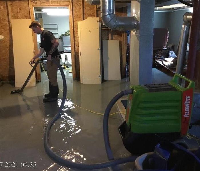 Crew Member Extracting Water from a Basement
