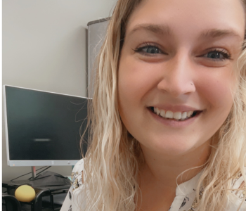 Women with blonde hair smiling in front of camera