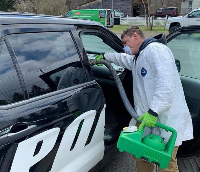 SERVPRO Employee Fogging Police Response Vehicle