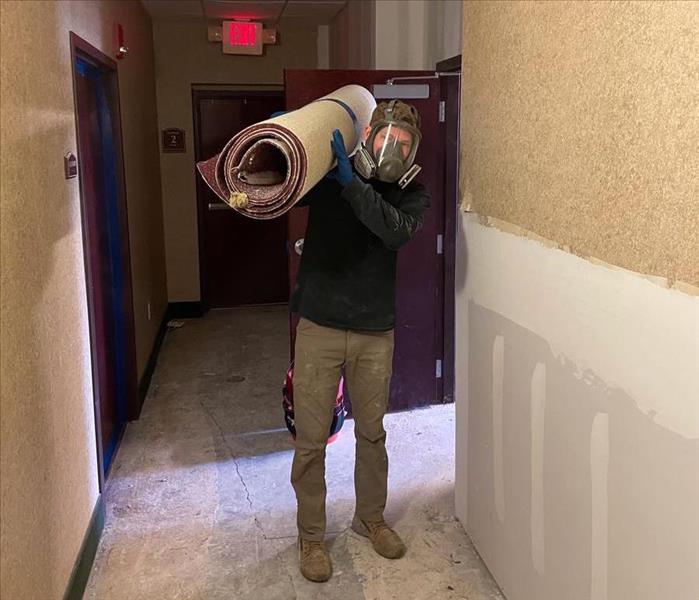 Crew Member Hauling Debris with Full face mask on